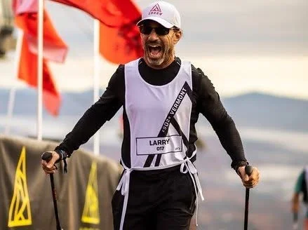 Larry smiling with trekking poles during the Under Armour Everest challenge