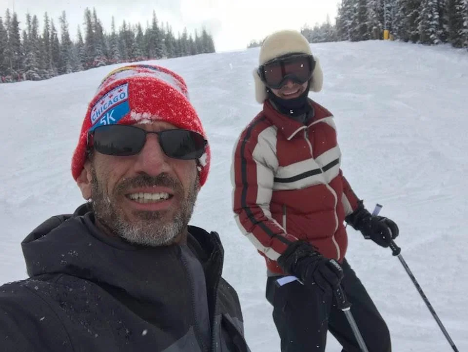 Larry with a friend on a snowy ski slope