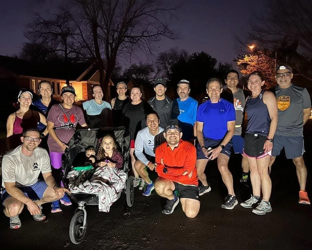 Larry and about twenty Sparks runners, some in headlamps, gathered on a dark neighborhood street with a child in a jogging stroller